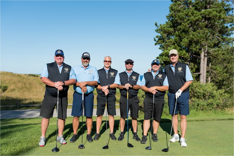 six men who played rugby posing at Arcadia Bluffs