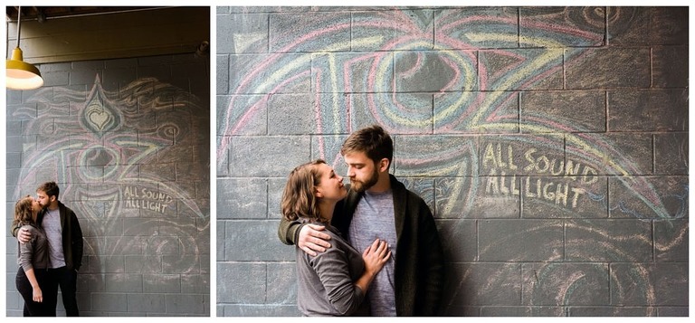 A couple in front of a chalk drawing