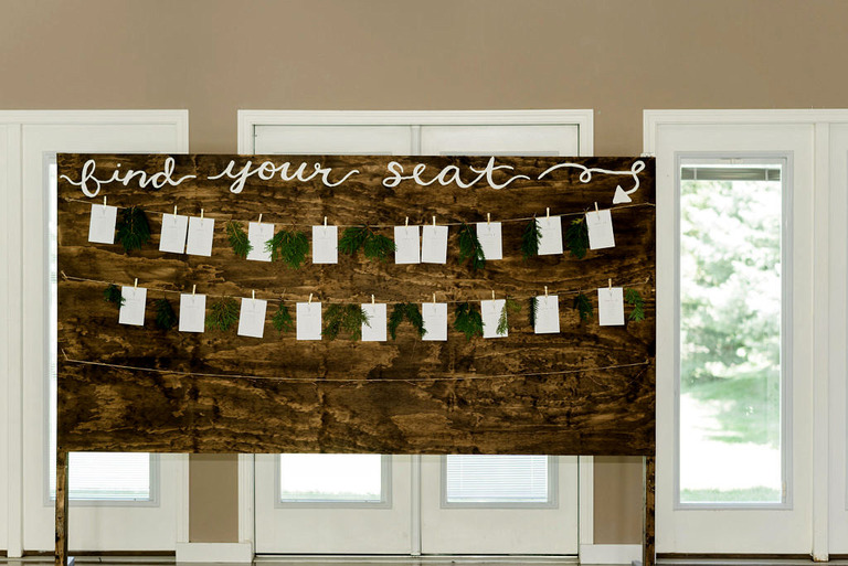 a rustic seating chart at fox hill