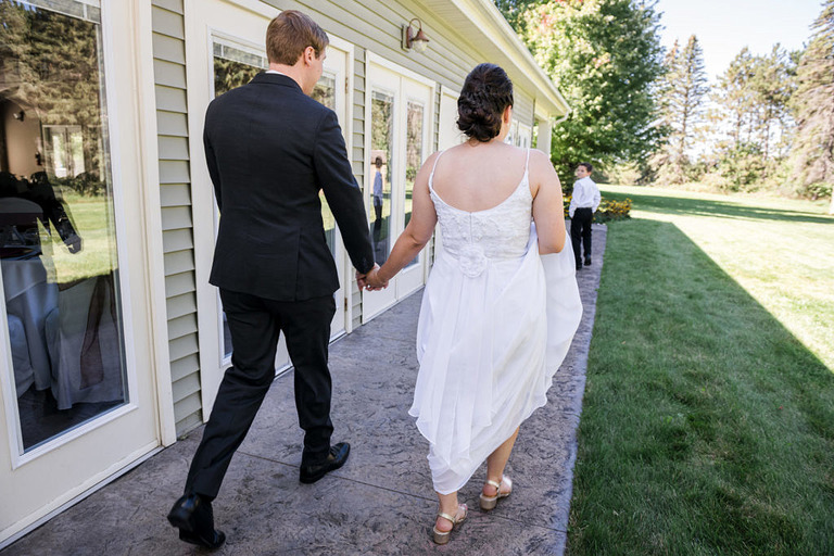 bridal couple walking at Fox Hill event center