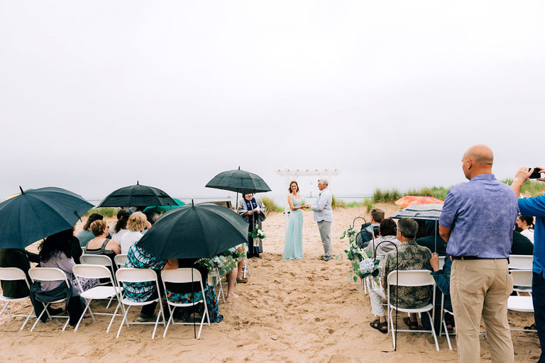 wedding couple at ceremony on frankfort michigan beach wedding