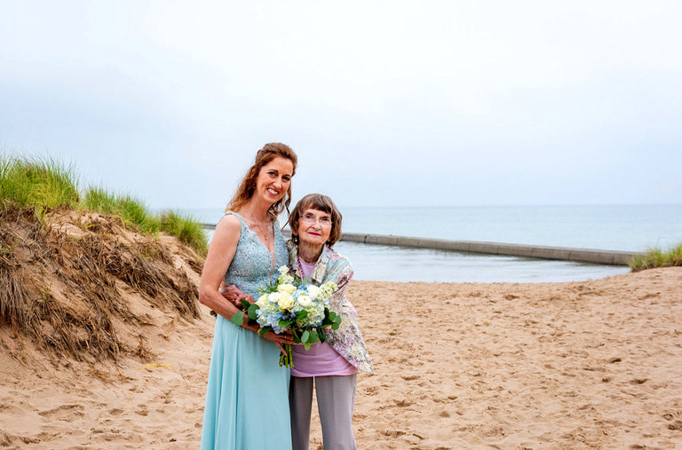 bride with her mom on frankfort michigan beach