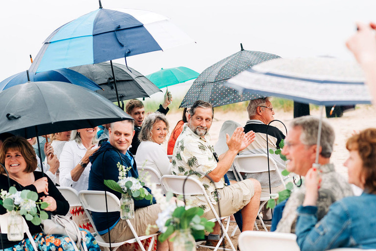 Frankfort beach wedding guests with umbrellas