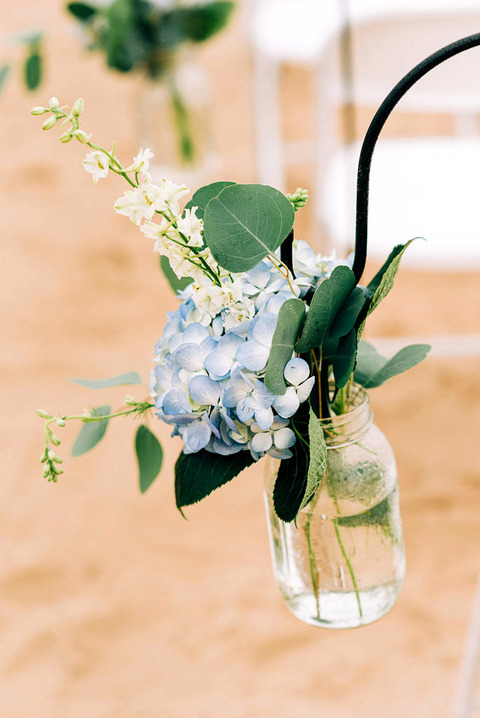 blue hydrangea flower arrangement hanging from a hook