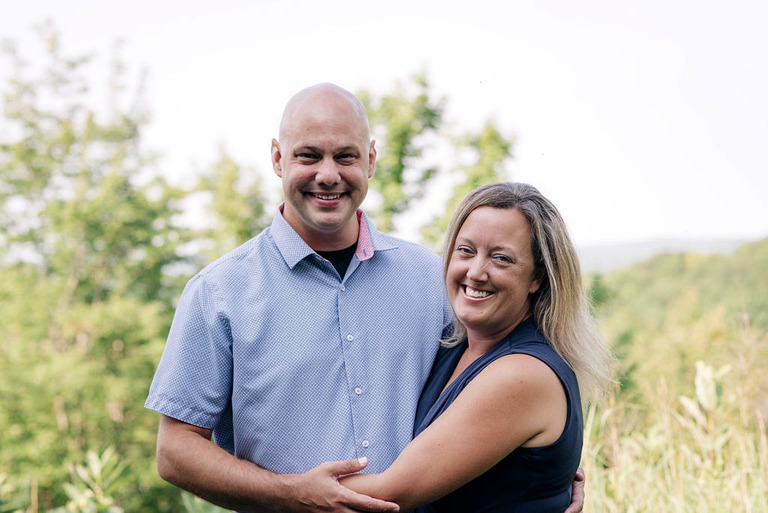 husband and wife headshot at Cystal Mountain in summer
