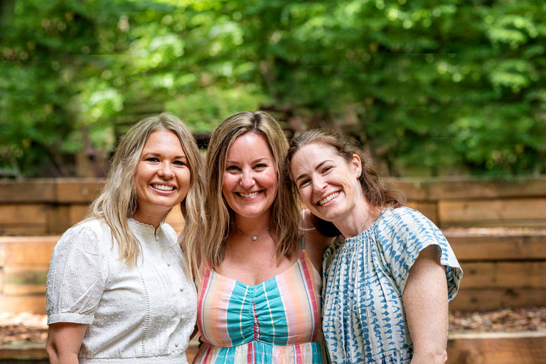 three smiling woman at michigan legacy art park