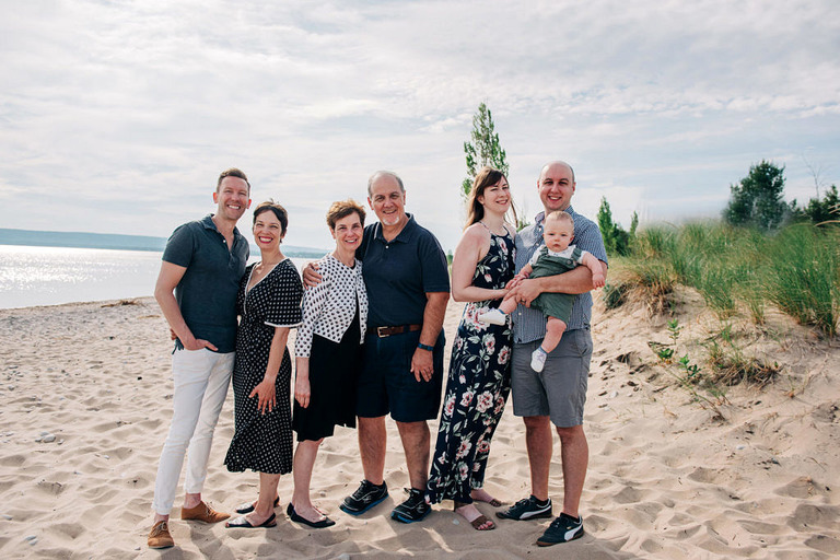 seven family memembers stand on the shoreline in Glen Haven Michigan