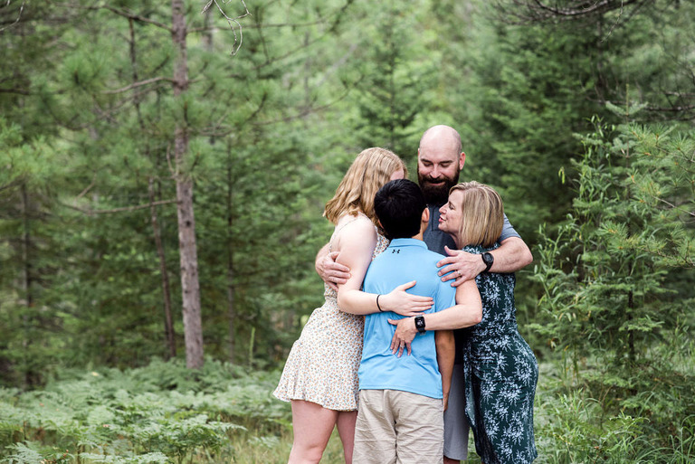 family hugging in grayling mi