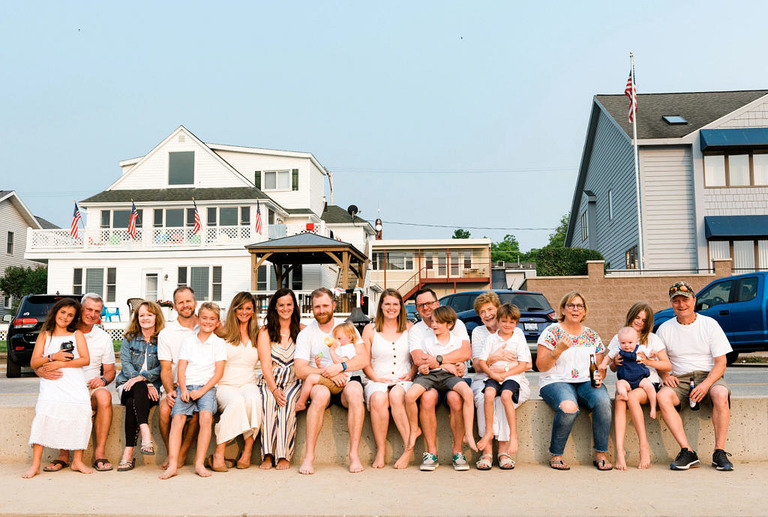 an informal portrait of twenty two people lined up for a photo at beulah public beach