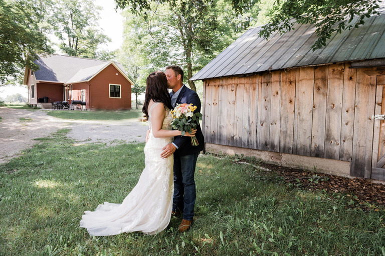 wedding first look and kiss at Iron Fish Distillery