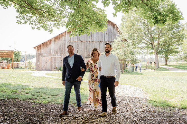 ceremony walk of mother down the aisle at Iron Fish Distillery