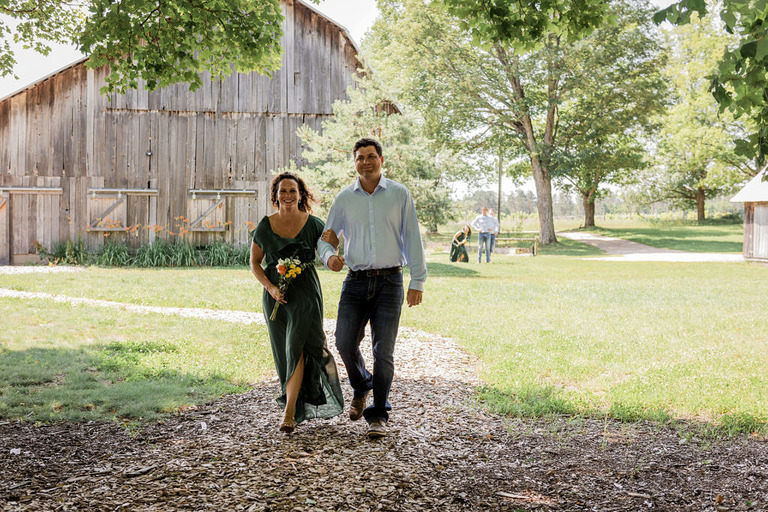 ceremony walk of couple down the aisle at Iron Fish Distillery