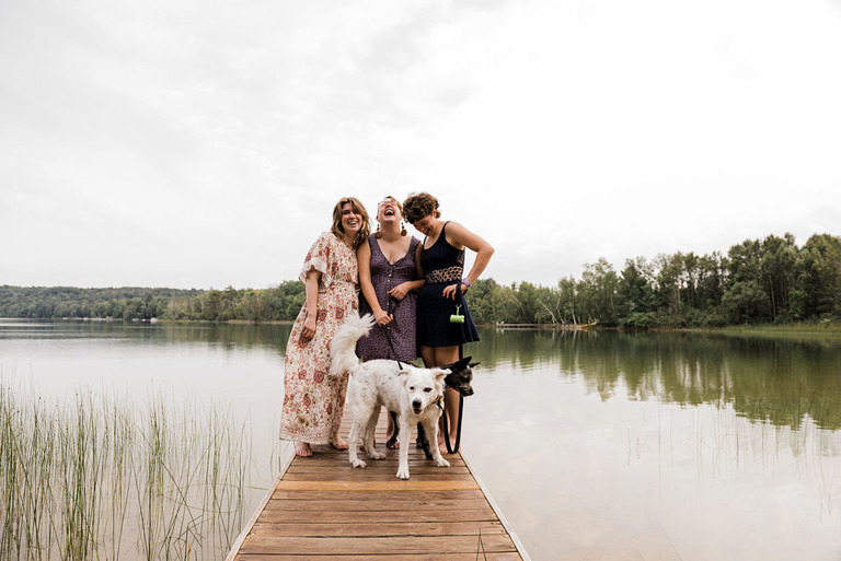 a group poses with two dogs at labrys resort