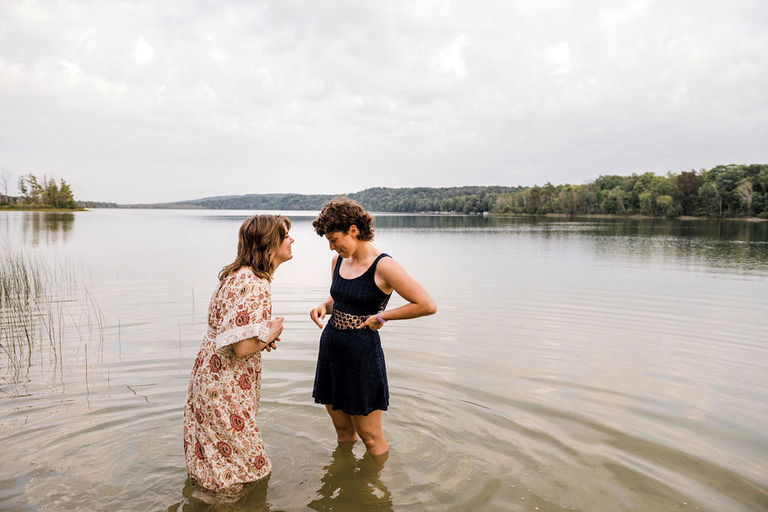two women walk into the lake at Labrys resort Frankfort, MI