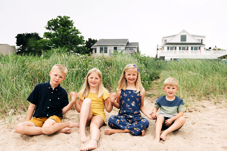 kids sitting on the sand at Crystal Lake mi beach