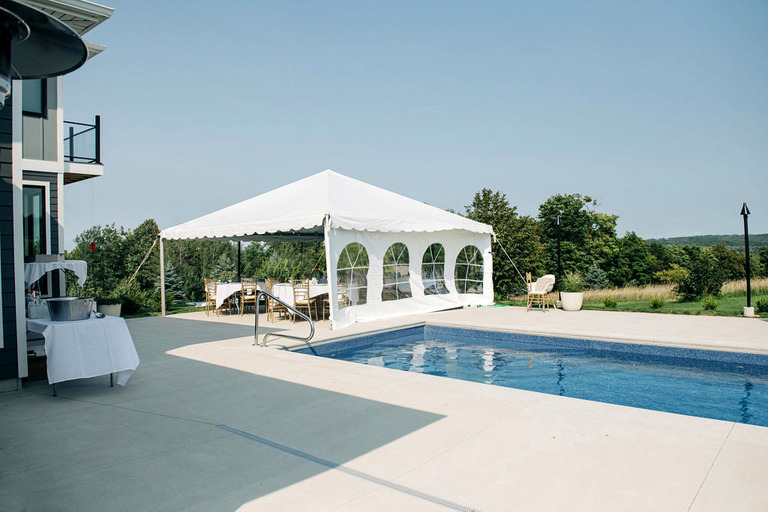 in ground pool and white tent at a lake leelanau micro wedding