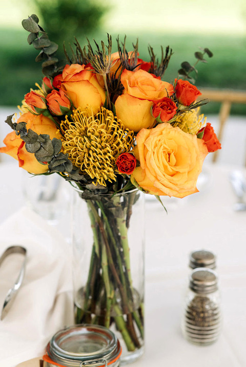 orange roses at a table 