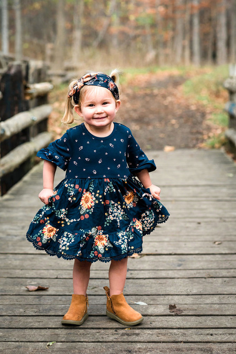 little girl dancing in a blue dress 