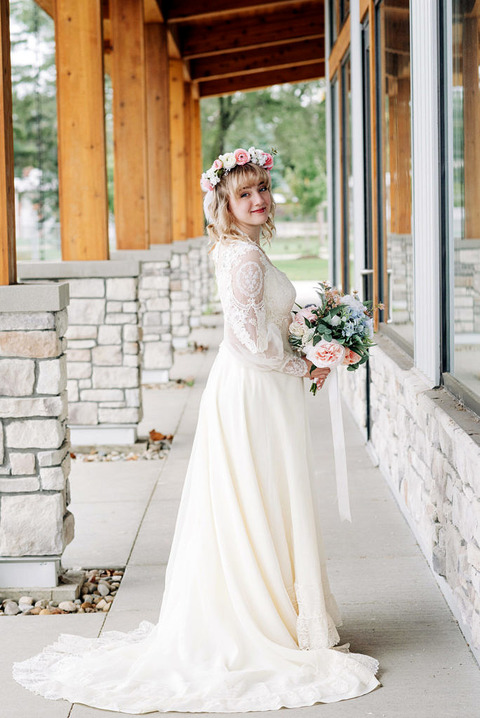a bride in a vintage dress outside at the american 1 event center