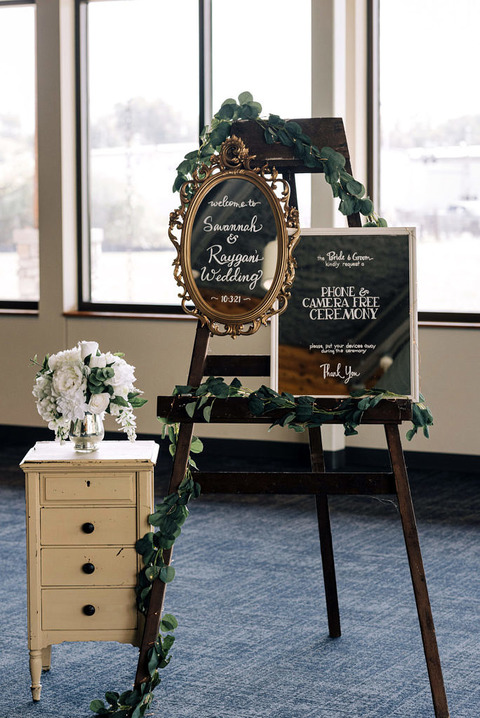 a vintage guest welcome stand explaining cell phone useage at a wedding