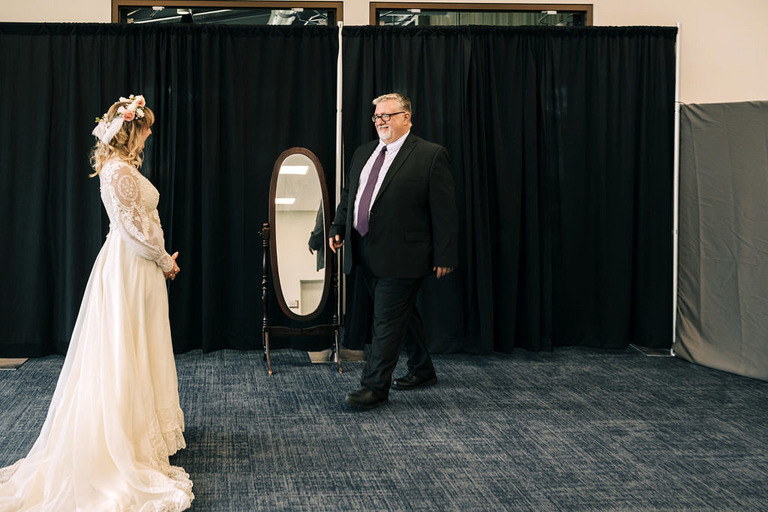 a dad sees his daughter in her vintage wedding dress for the first time