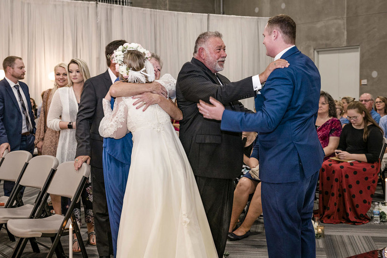 bride and groom hug guests after the ceremony in Jackson, Mi