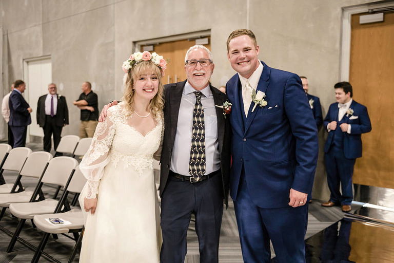 bride and groom with pastor Tim Flickinger