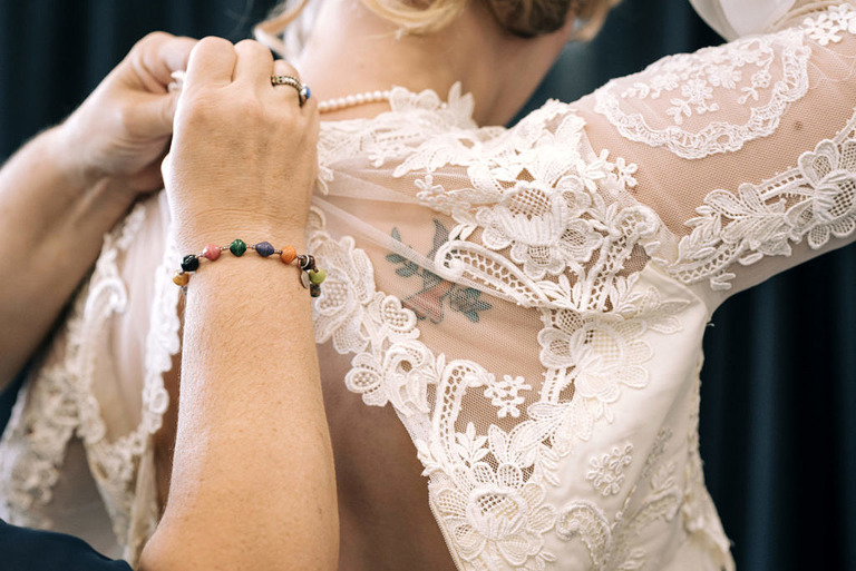 vintage lace back of wedding dress with bluebird tattoo