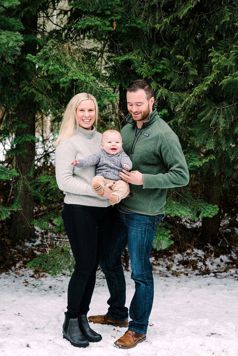 a small family group with a smiling baby in leland, mi