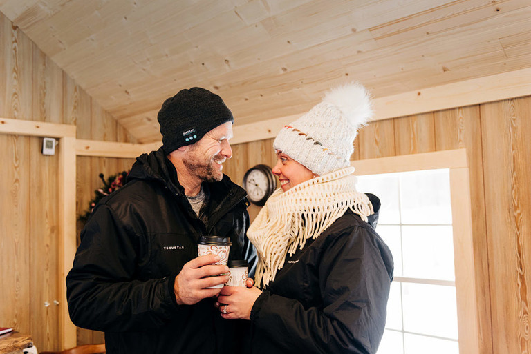 a newly engaged couple share hot chocolate at fantail farm