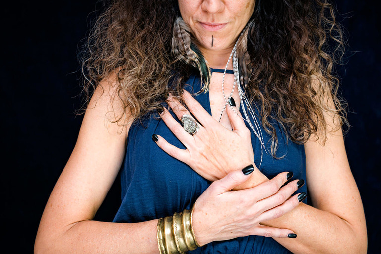 warrior hands with gold cuff bracelets and black nails