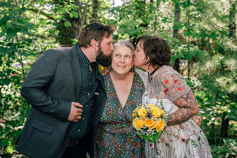 bride and groom with mom at traverse city wedding