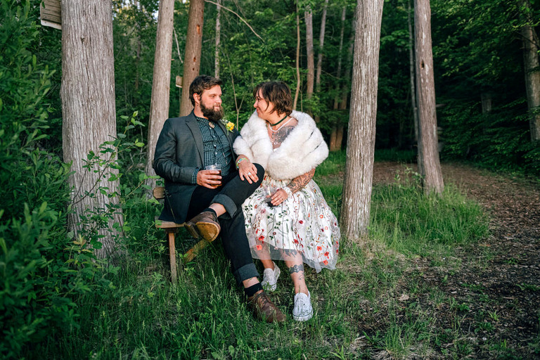 a newly married couple relaxing in the woods at blue bridge