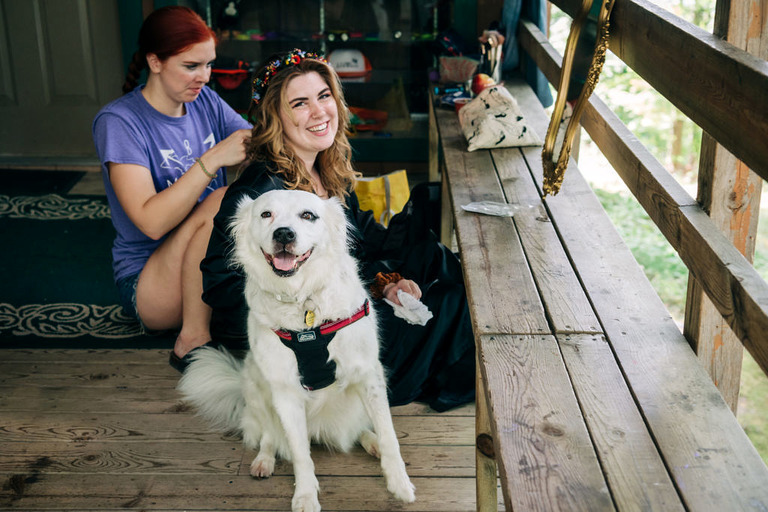 a woman and her dog smile at the camera at camp kidwell.