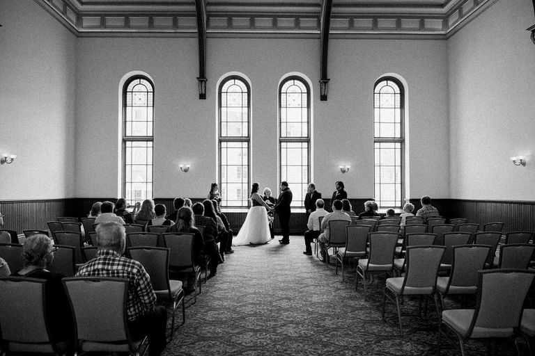 a black and white image of a man and woman being married in Traverse City.