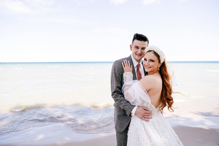 a wedding couple in front of Lake Michigan in Northport