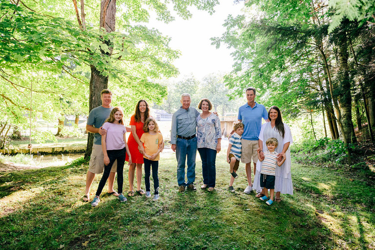 A family is in the woods in Mesick michigan for family photos