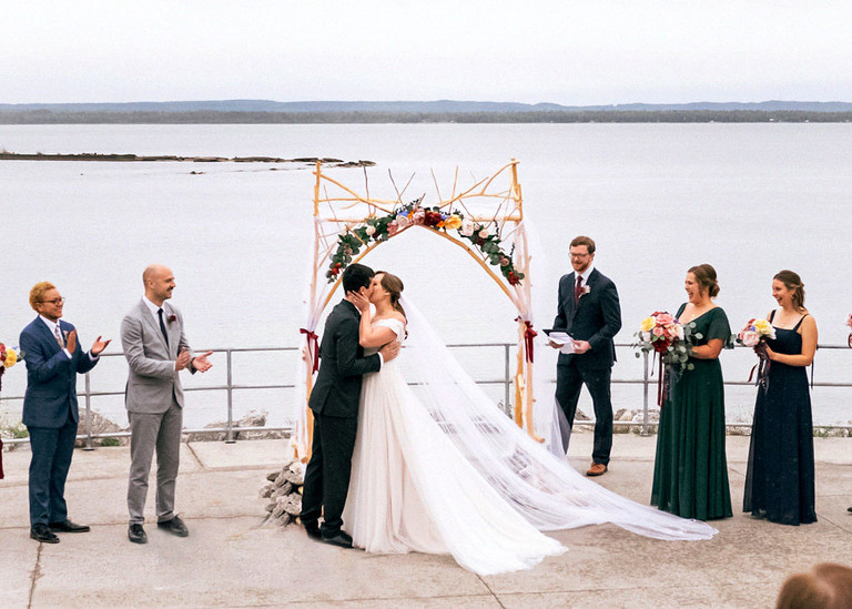 First kiss during a wedding ceremony outside at Headlands International Dark Sky park.