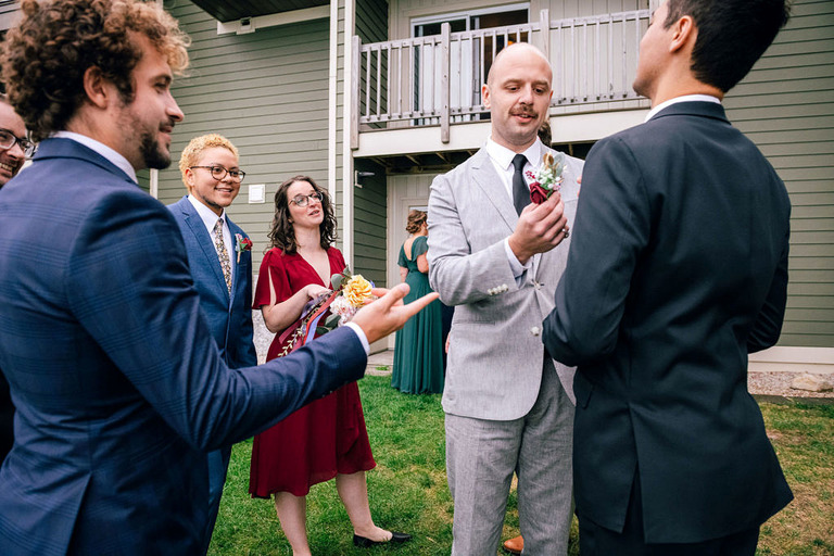 a group of the groom's friends gathers in a candid and vibrant photo.