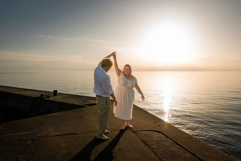 a couple dances on the breakwall in Frankfort.
