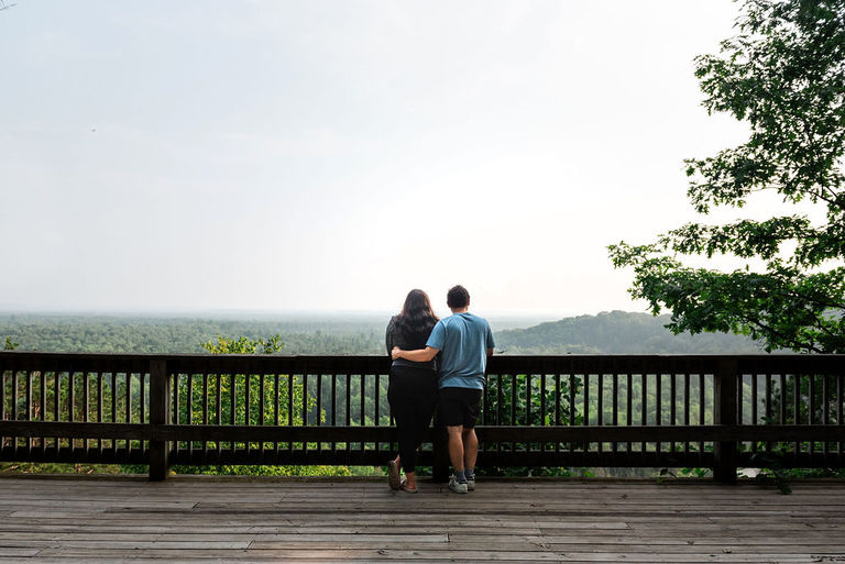 a photo of a man and woman looking out over the platform on the high rollaway trail for engagement pictures.