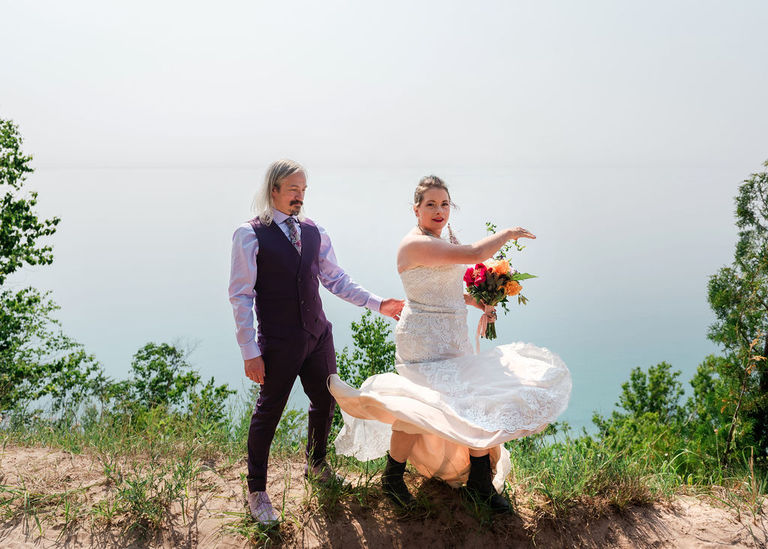 The bride throws her dress in a circle high above Lake Michigan. 