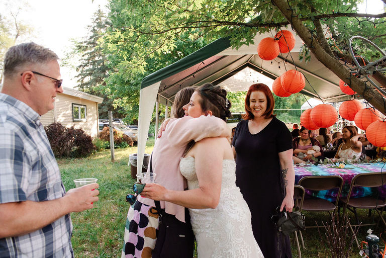 a guest hugs the bride