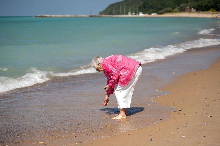 The Grandma looks for rocks on Lake Michigan.