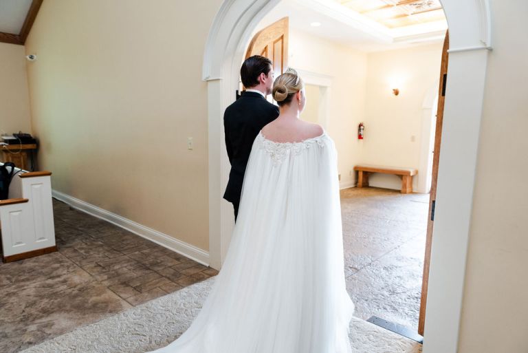 A newly married couple walks out the chapel doors at Hawk Hollow Chapel.