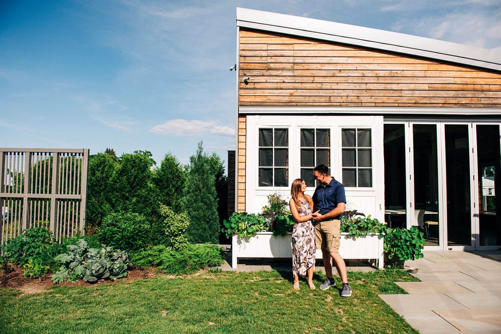 A couple embraces in front of a building in northern Michigan.