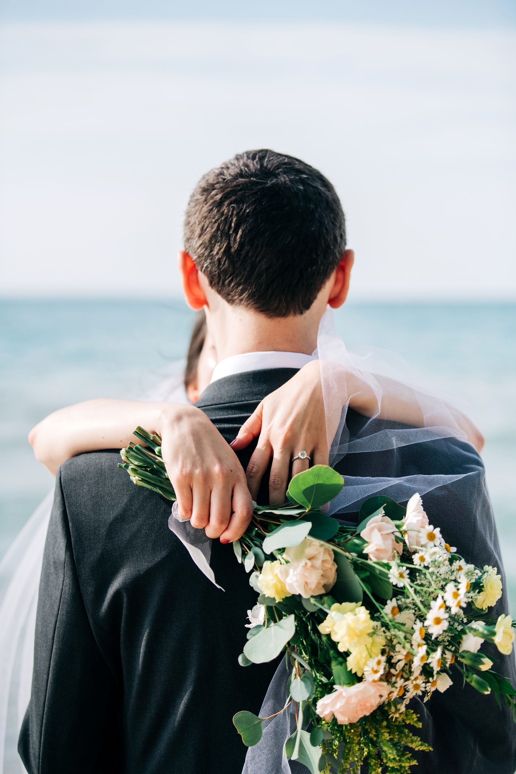 A micro wedding couple's close portrait on the beach in Kewadin, MI.