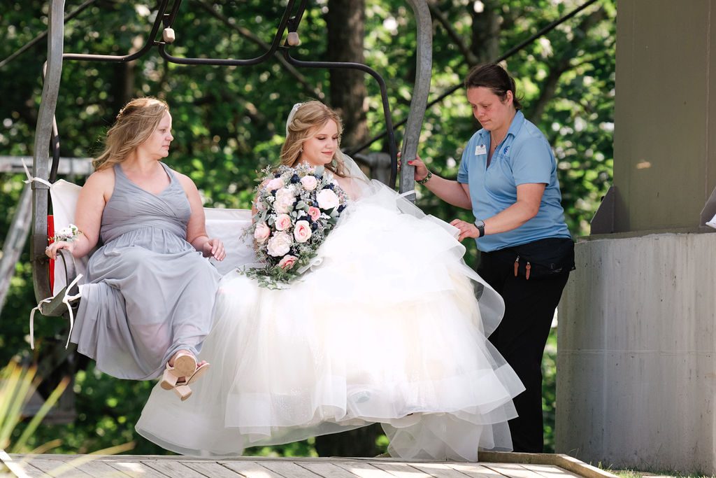 the bride and her mother arrive to the processional on a ski lift at crystal mountain