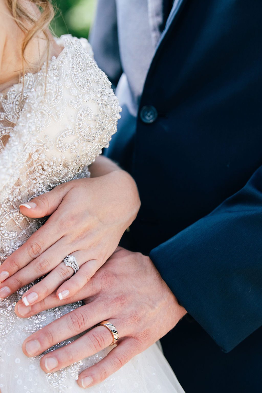 the hands and rings of the wedding couple