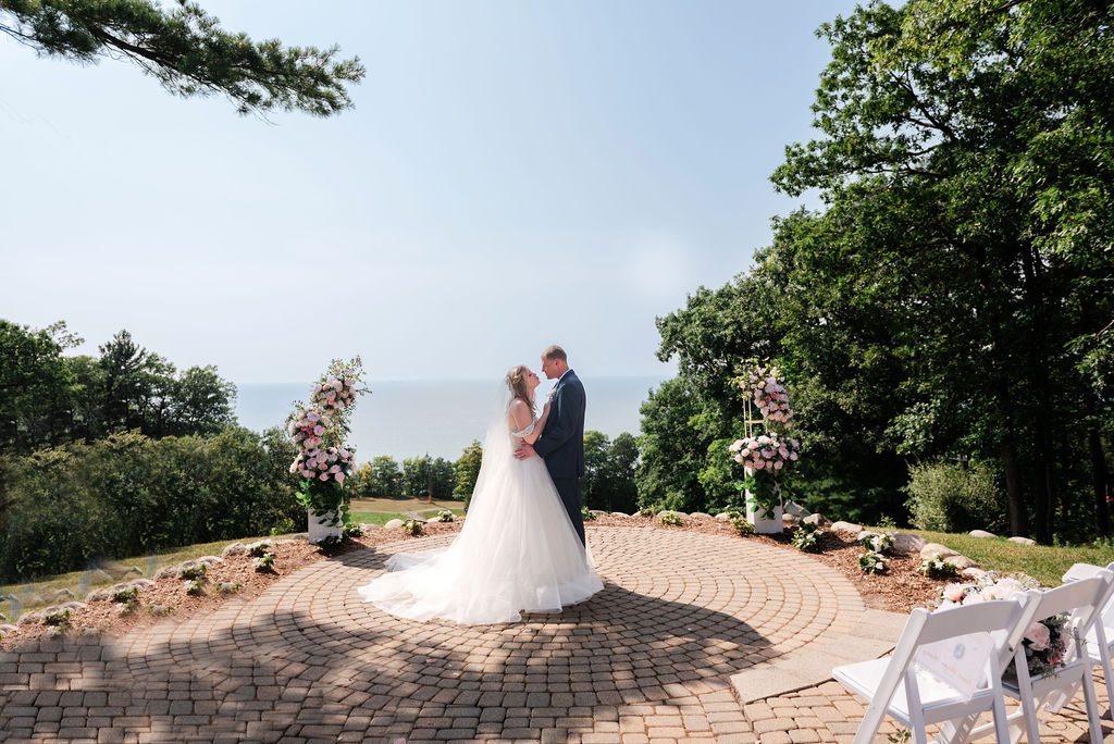 a bride and groom embrace on the overlook at crystal mountain for their wedding